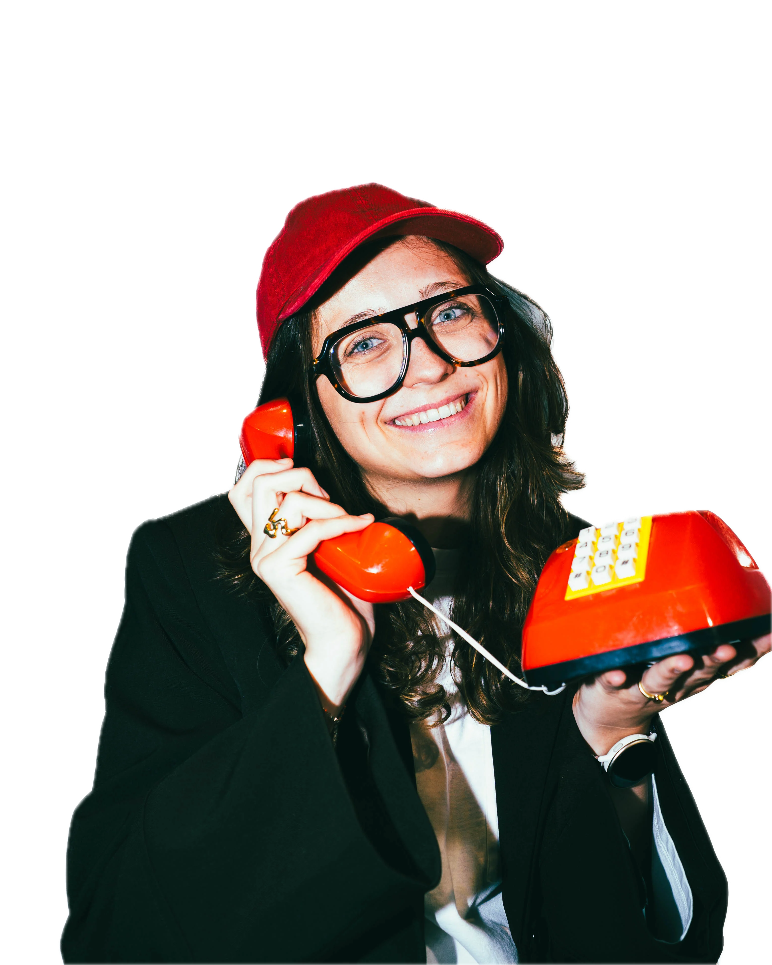 Girl with a hat, smiling with a red retro telephone in her hands