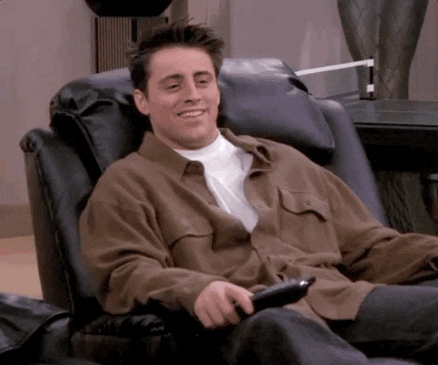 Joey from friends sitting in his lounge chair GIF.