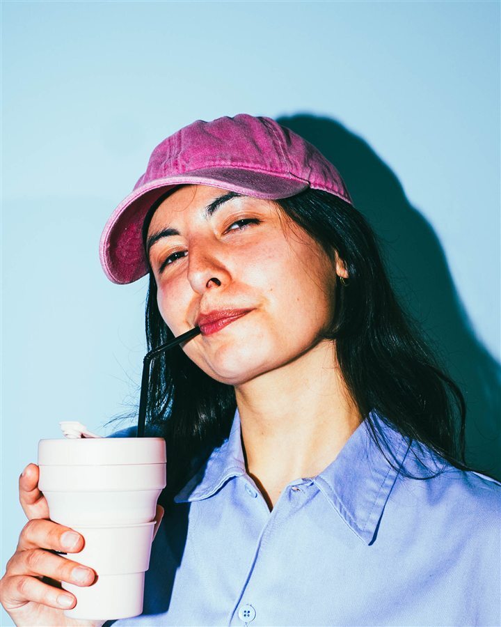 Young woman with a pink cap.